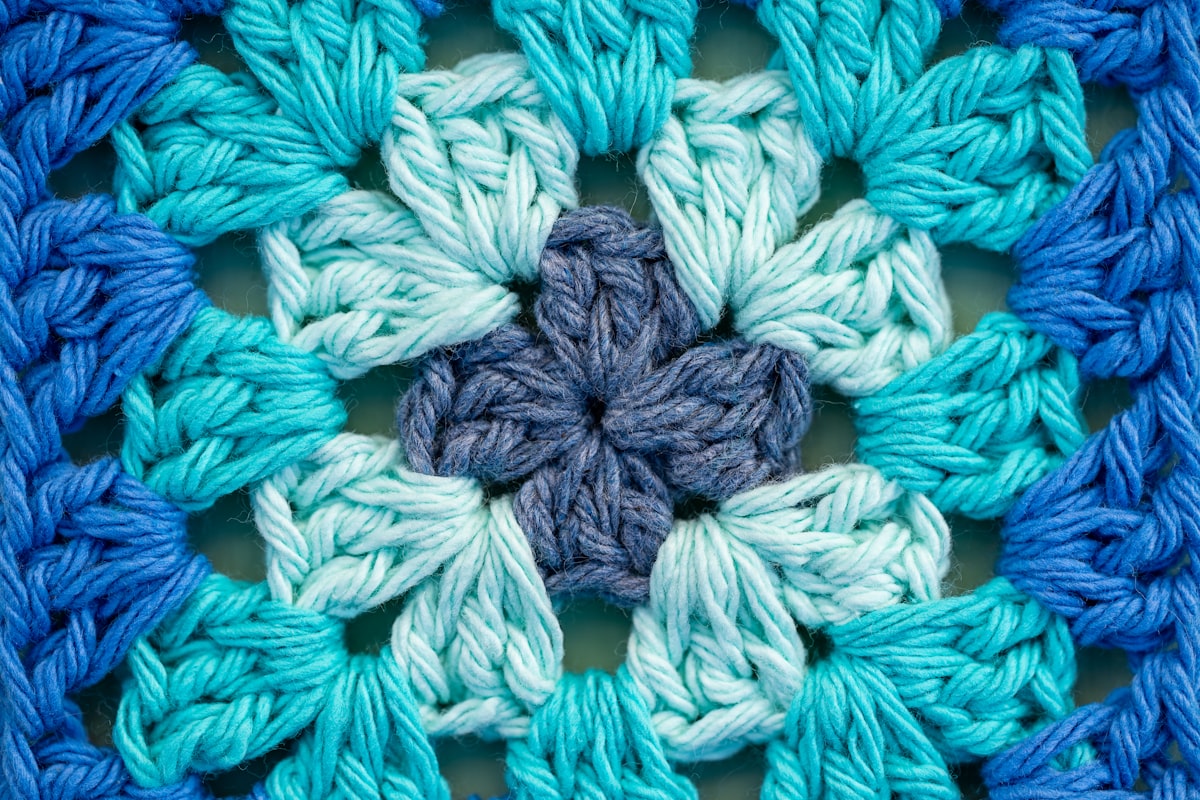 Close-up of a blue and teal crocheted granny square